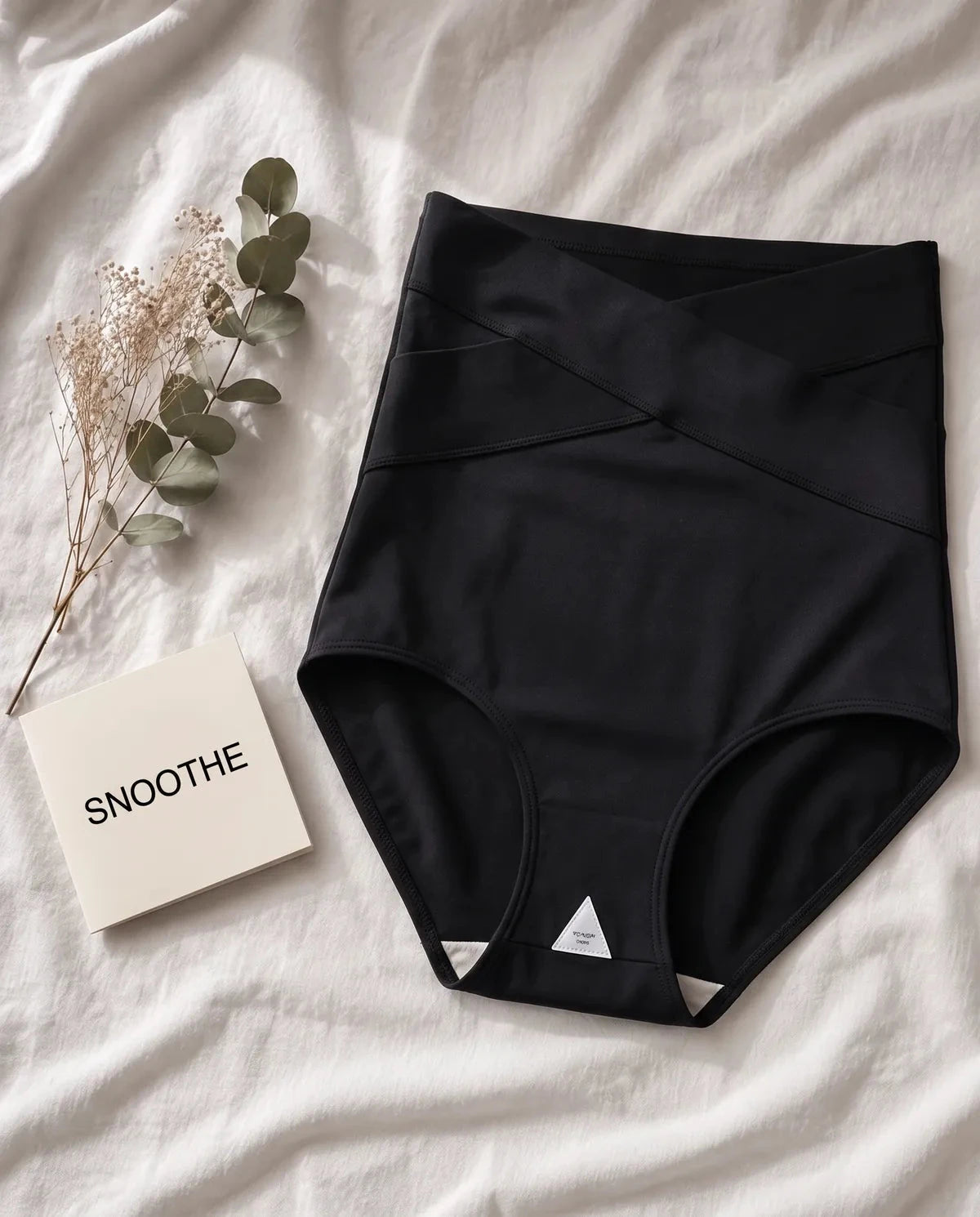 Black Snoothe support brief laid on white linen
